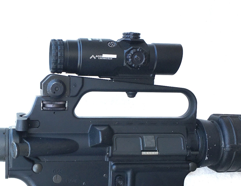 The PA fits perfectly in a carry handle with the low riser and takes the ACOG screw