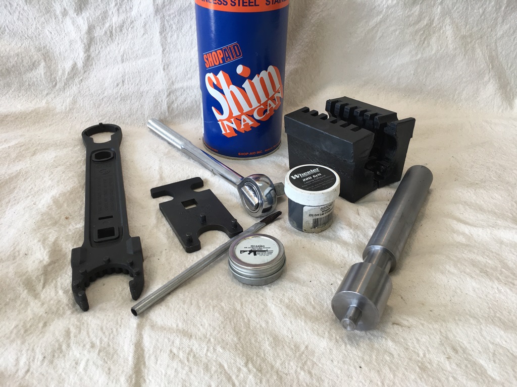 Barrel assembly tools: nut wrench, action block, 0.001" stainless steel shim stock, receiver face lapping tool, 220 grit lapping compound, aeroshell grease and brush